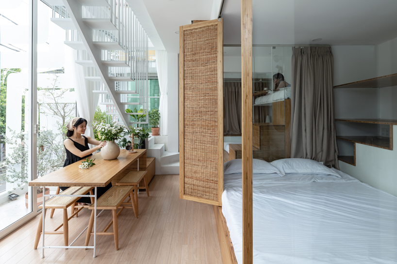 NKAA stacks a café and family home onto a corner site in hue, vietnam designboom