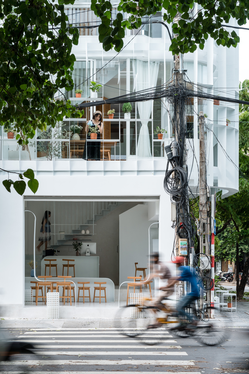 NKAA stacks a café and family home onto a corner site in hue, vietnam designboom