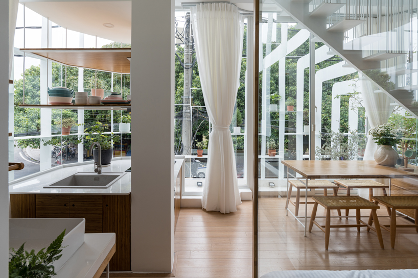 NKAA stacks a café and family home onto a corner site in hue, vietnam designboom