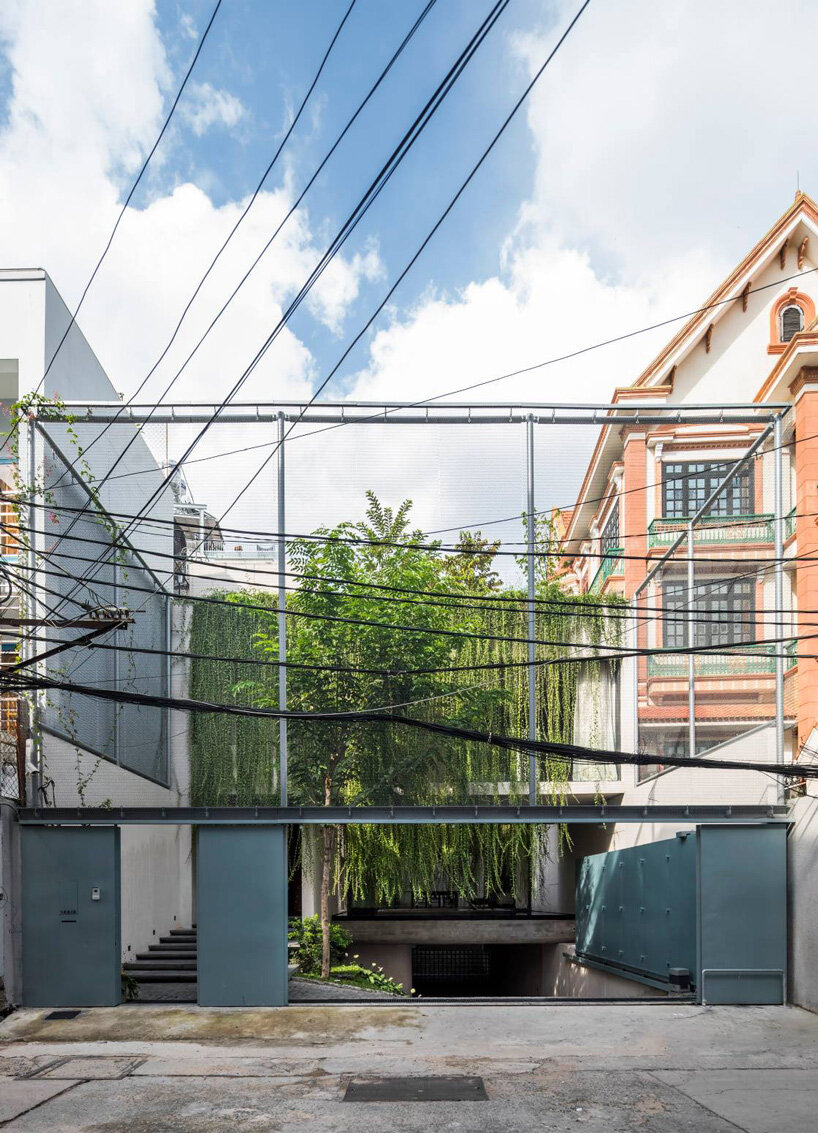 open courtyards with lush greenery complete MIA design studio's concrete house in vietnam