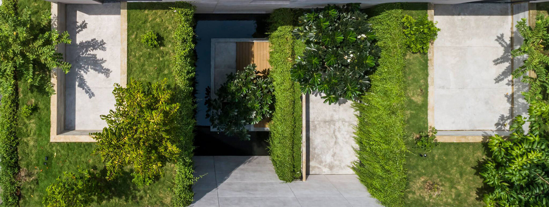 open courtyards with lush greenery complete MIA design studio's concrete house in vietnam - 11