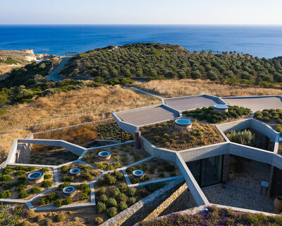 DECA architecture translates voronoi diagram into sunken 'hourglass corral' house in greece