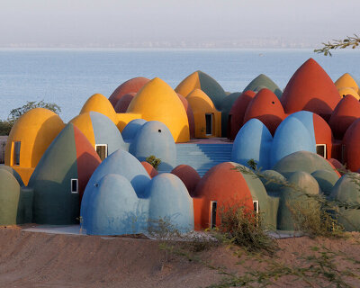 ZAV architects builds colorful village of rammed earth domes on iran's hormuz island