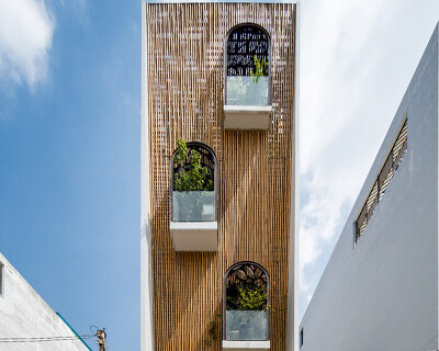 woven bamboo façade clads atelier ngng's 'floating nest' house in vietnam