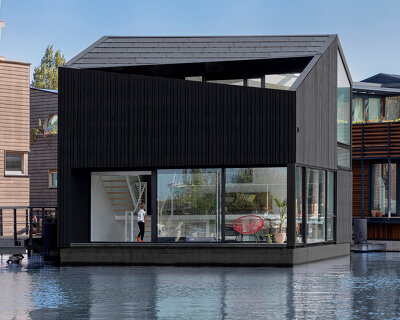 i29 architects completes angular timber house as part of a floating village in amsterdam