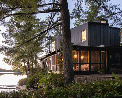 paul bernier architecte tops rustic log cabin in canada with monolithic wood-clad extension
