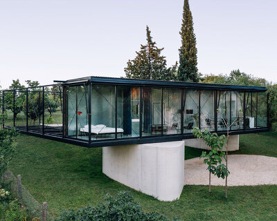 TEN studio sets steel-frame house atop two boulder-like concrete volumes in rural serbia