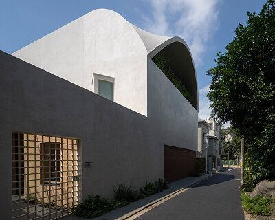 a 'sky cave' crowns this three-storey building in tokyo by IKAWAYA architects