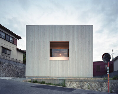 a picture frame window punctures house in himeji by fujiwaramuro architects in japan