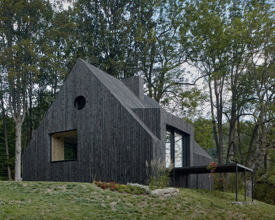 mjölk architekti wraps its cottage pod bukovou in a skin of blackened timber