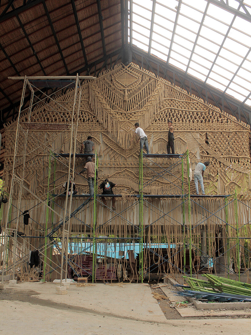 agnes hansella hangs massive macramé wall trio on a seaside structure in bali