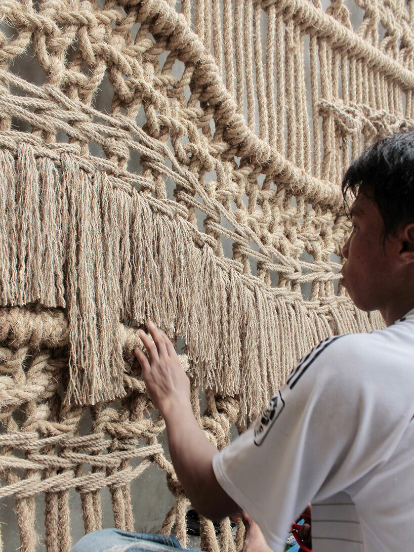 agnes hansella hangs massive macramé wall trio on a seaside structure in bali