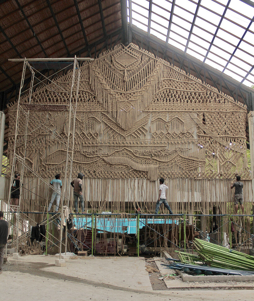 agnes hansella hangs massive macramé wall trio on a seaside structure in bali - 1