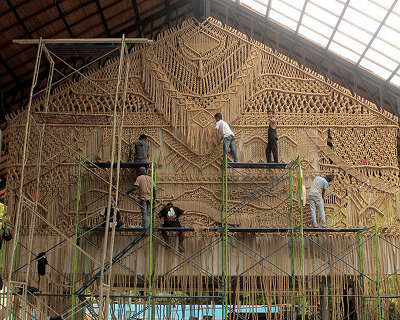 agnes hansella hangs massive macramé wall trio on a seaside structure in bali
