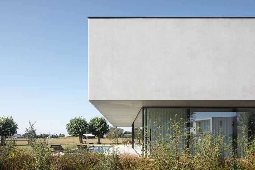 'residence DDE' by govaert & vanhoutte architects is a minimal concrete villa in rural belgium