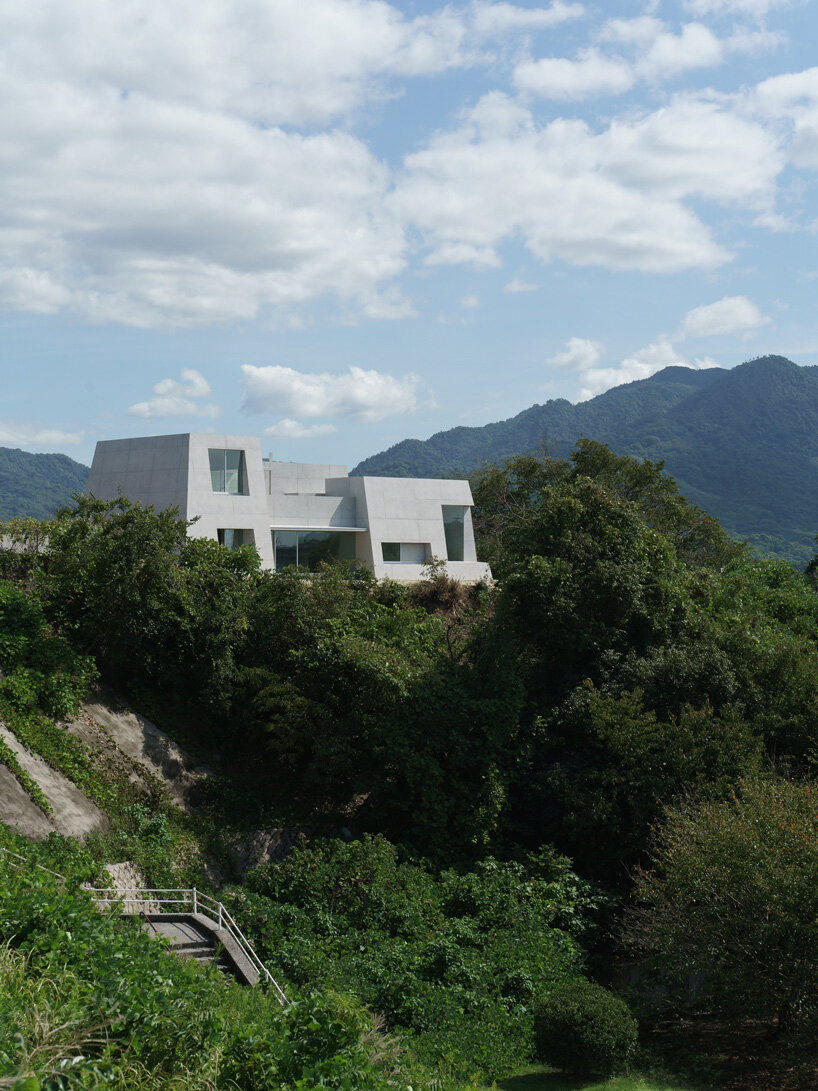 kazunori fujimoto architects builds fort-like house in japan with thick concrete exterior