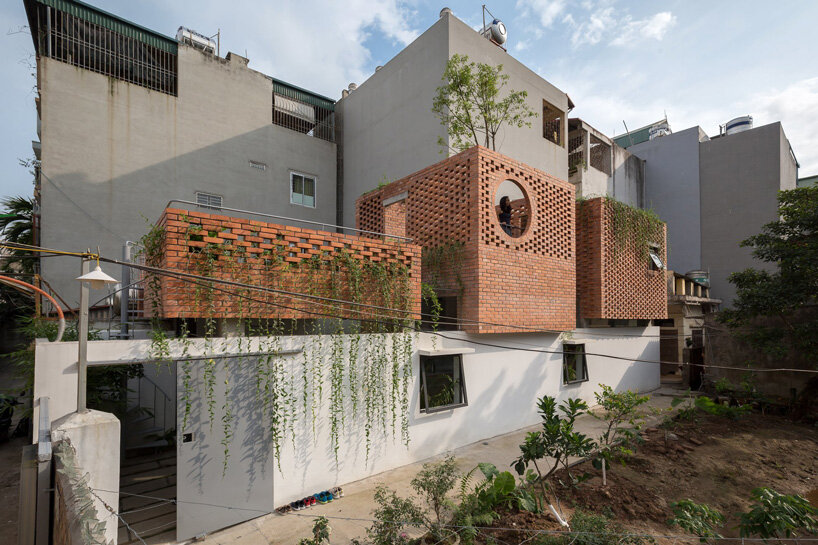 ODDO architects incorporates round window into the brick exterior of VH house in hanoi