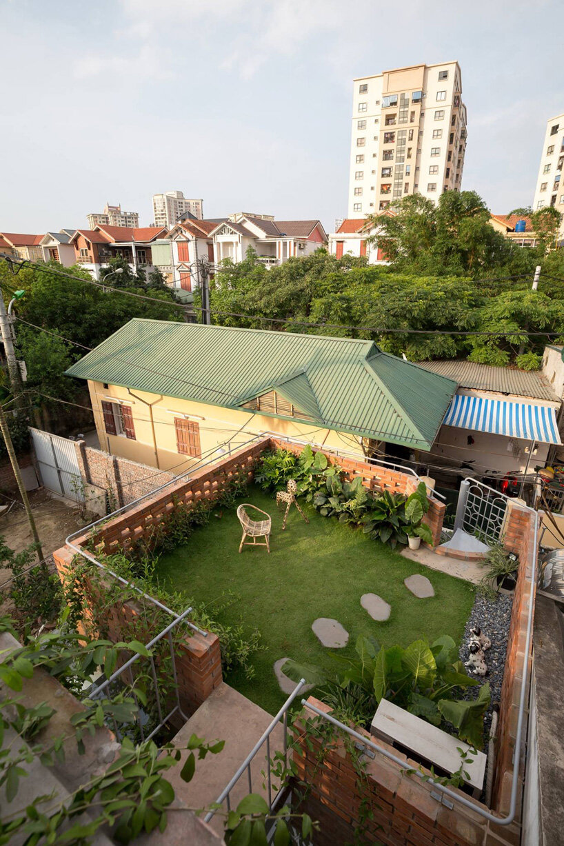 ODDO architects incorporates round window into the brickwork of VH house in hanoi