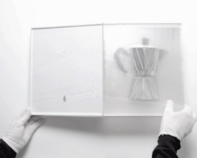 a sliced coffee pot encased in resin pages forms the dissected 'bialetti book' by studio oefner