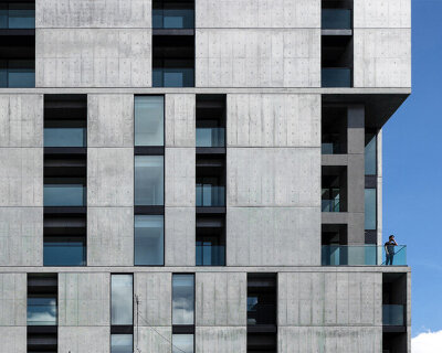 takuyahosokai's concrete housing complex in niigata contains 34 dwellings