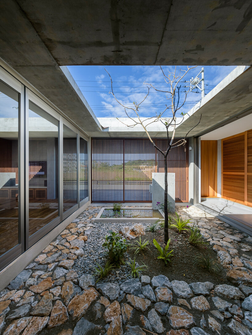 studio cochi architects develops concrete house around central open courtyard in japan