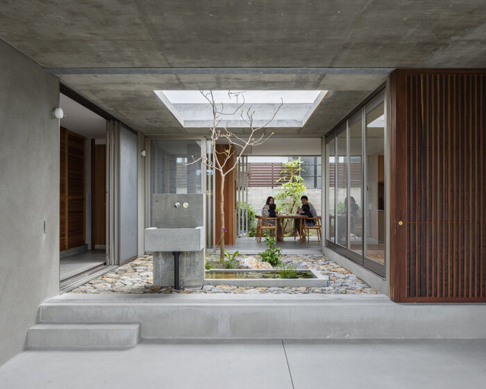 studio cochi architects develops concrete house around central open courtyard in japan