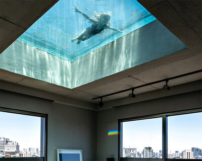 all-glass swimming pool filters sunlight within spacious penthouse renovation in brazil