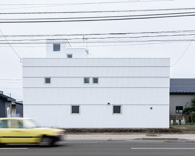 jun igarashi completes the private 'tunnel and trapezoid' house in hokkaido, japan
