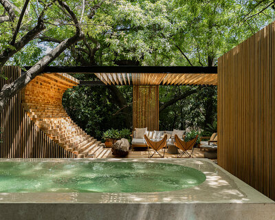 staggered timber-clad volumes nestle casa mague between the trees of malinalco, mexico