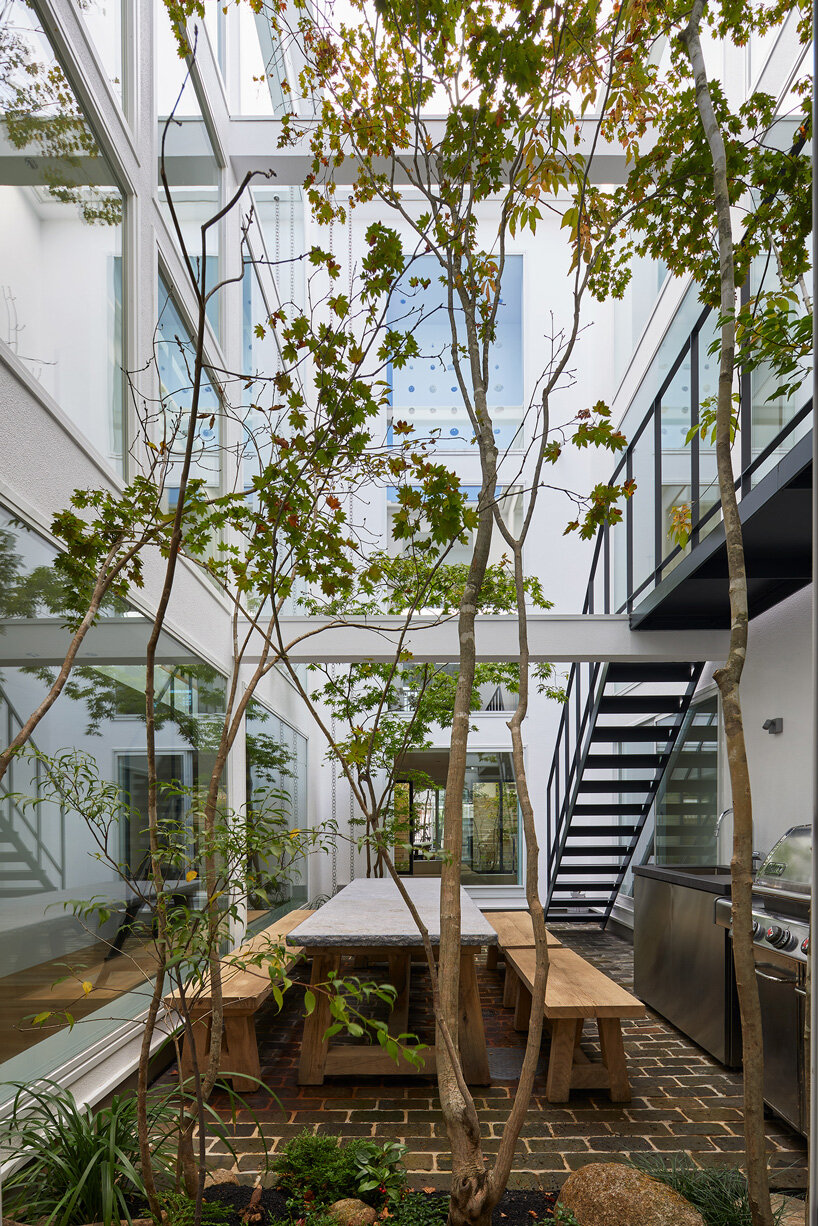 naf architect & design inserts glass courtyard in the center of this tokyo house