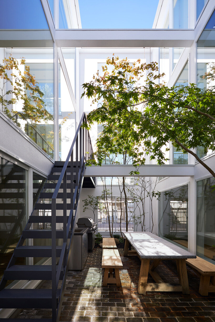 naf architect & design inserts glass courtyard in the center of this tokyo house