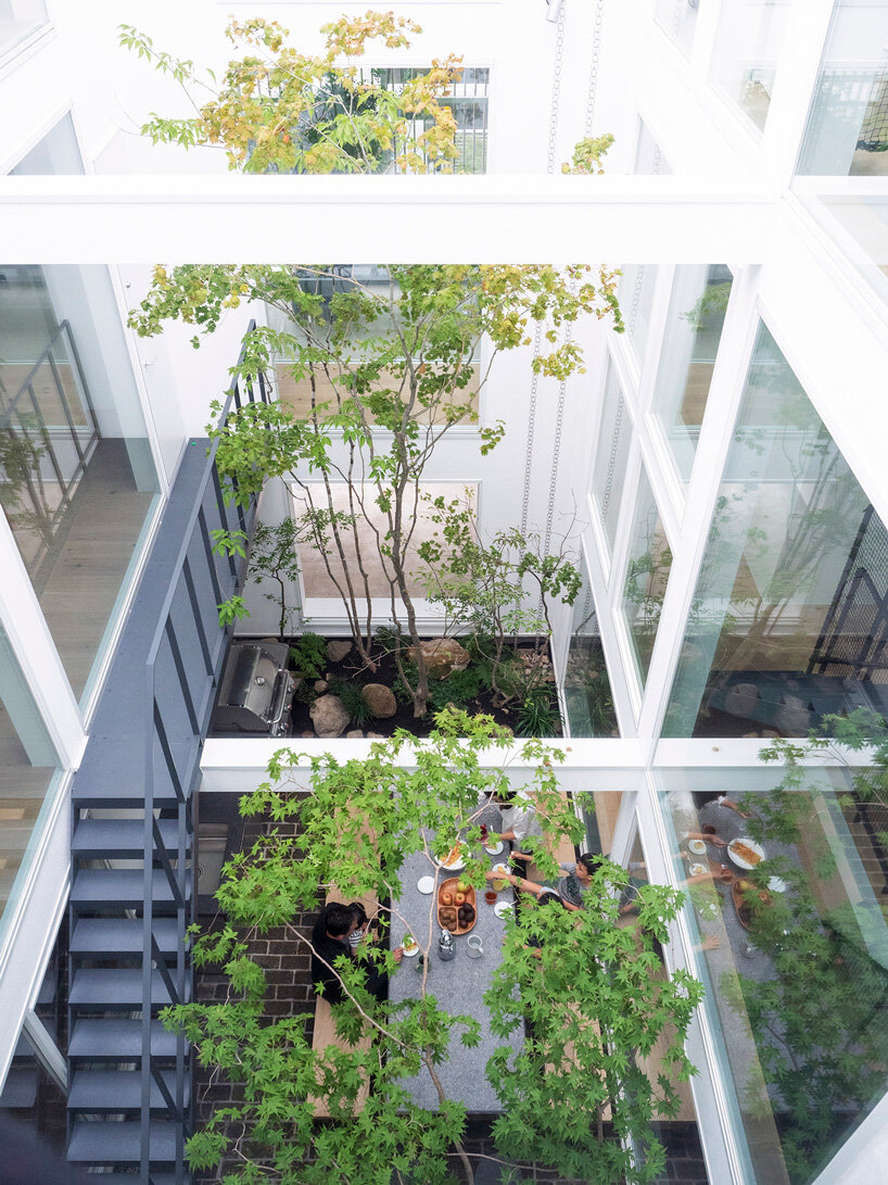 naf architect & design inserts glass courtyard in the center of this tokyo house