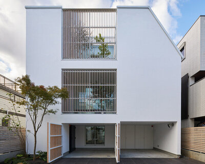 naf architect & design inserts glass courtyard in the center of this tokyo house