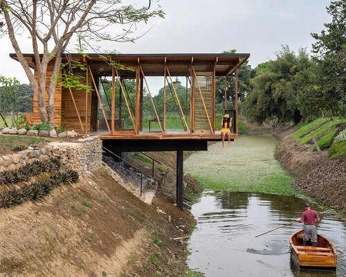 natura futura raises a timber-built tea room over a water channel in los rios, ecuador