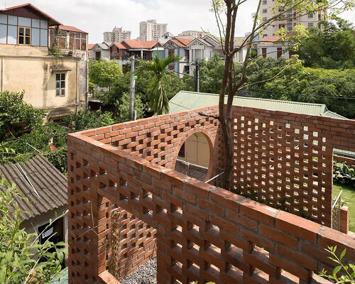 ODDO architects incorporates round window into the brick exterior of VH house in hanoi