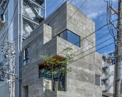 five-story atrium brings natural light into keitaro muto's concrete apartment building in japan