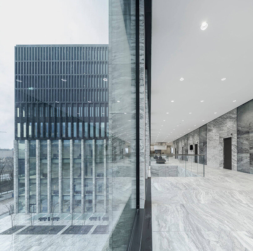 grand circular staircase spirals in the largest courthouse by KAAN architecten in amsterdam