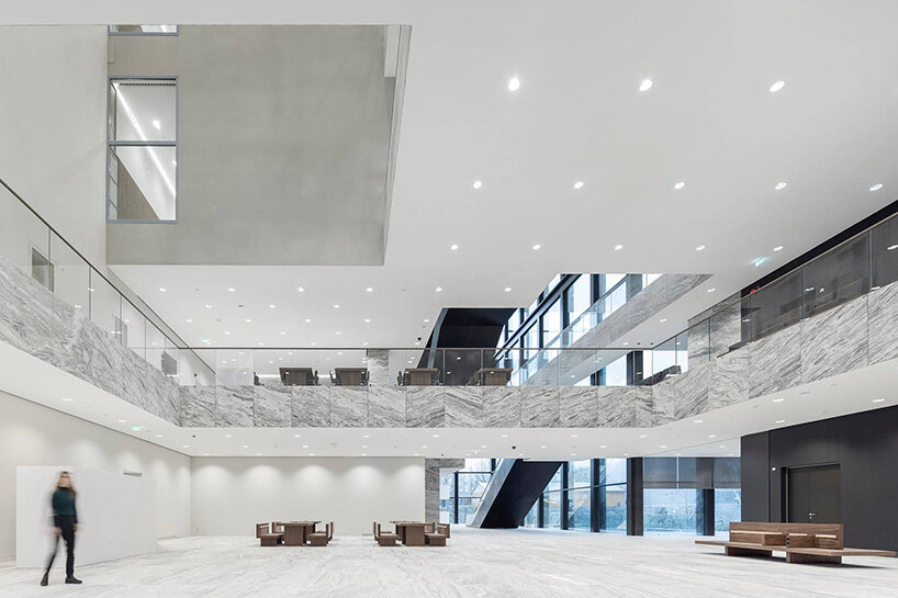 grand circular staircase spirals in the largest courthouse by KAAN architecten in amsterdam