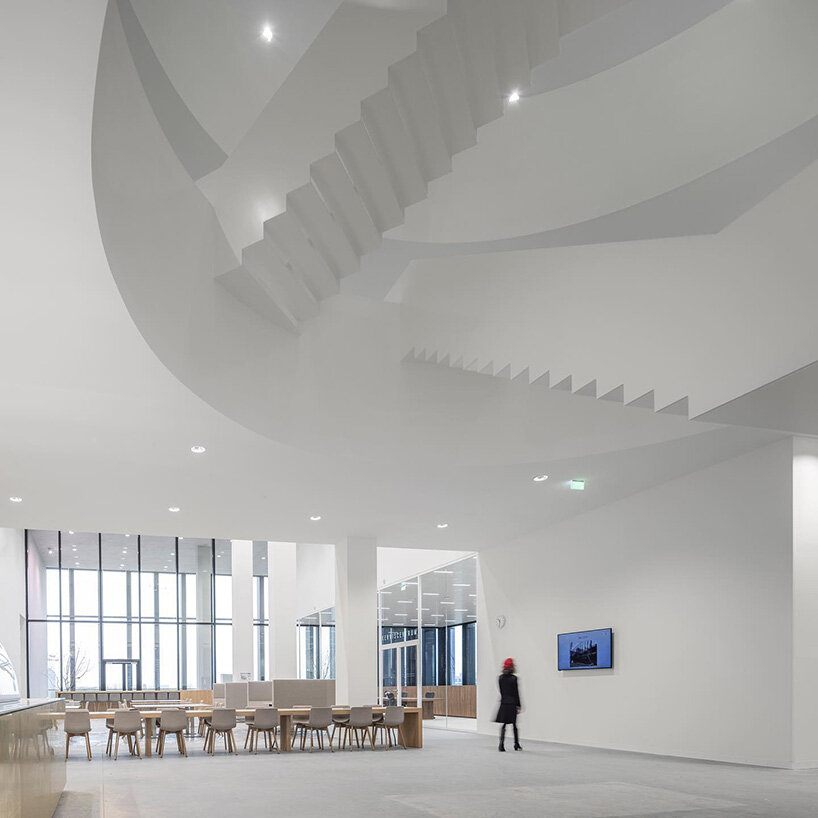 grand circular staircase spirals in the largest courthouse by KAAN architecten in amsterdam