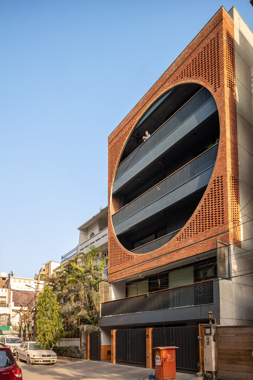 grand circular aperture within square brick screen dominates AKDA's family house in india