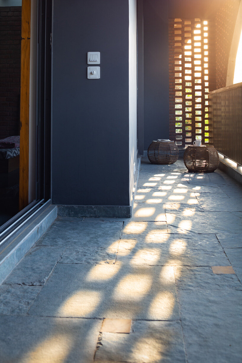 grand circular aperture within square brick screen dominates AKDA's family house in india
