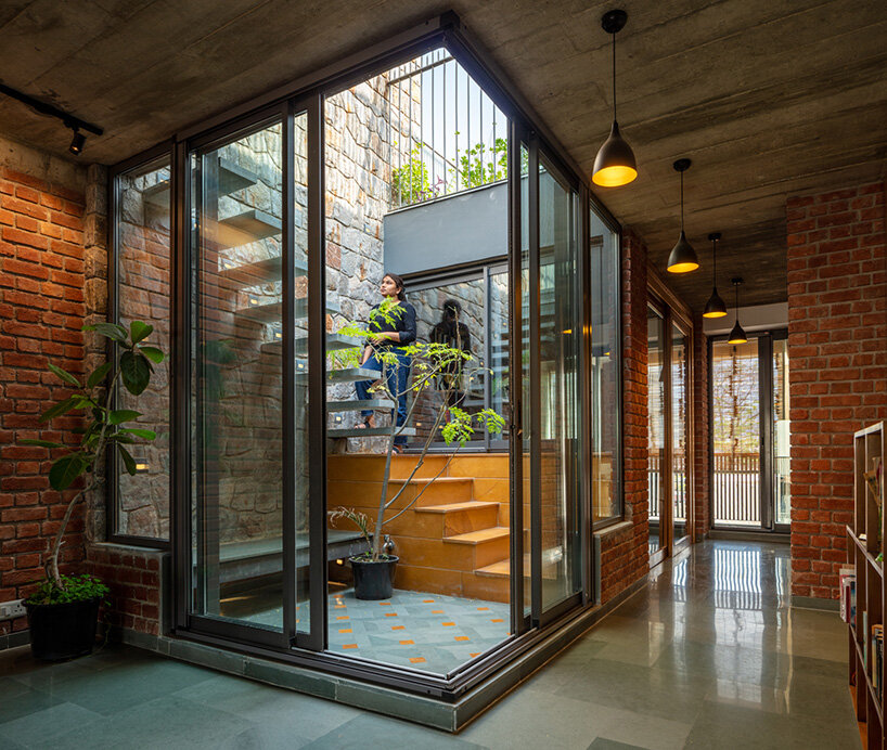 grand circular aperture within square brick screen dominates AKDA's family house in india