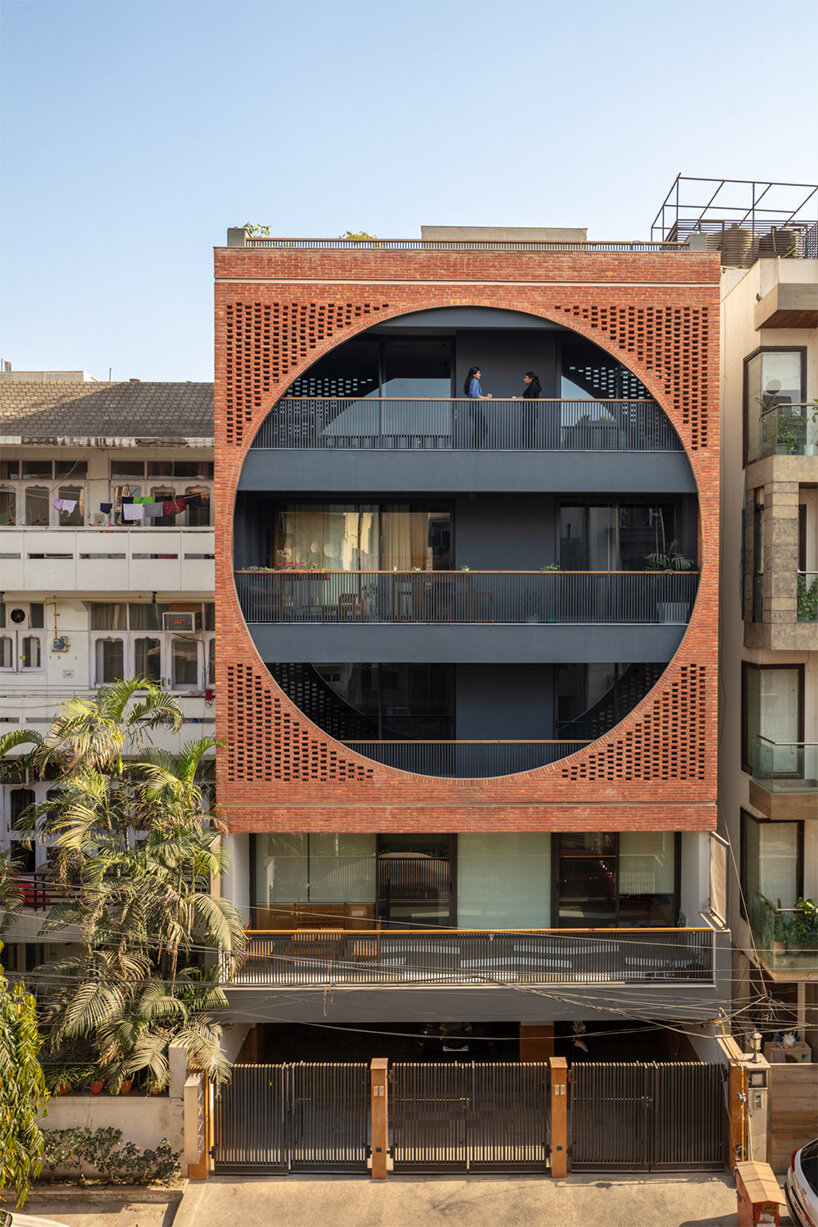 grand circular aperture within square brick screen dominates AKDA's family house in india