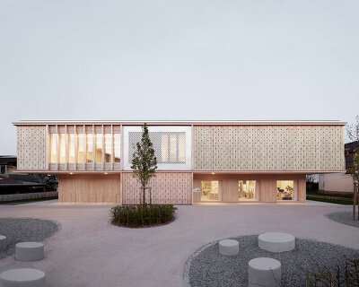 innauer matt's kindergarten engelbach is wrapped in a delicate timber facade