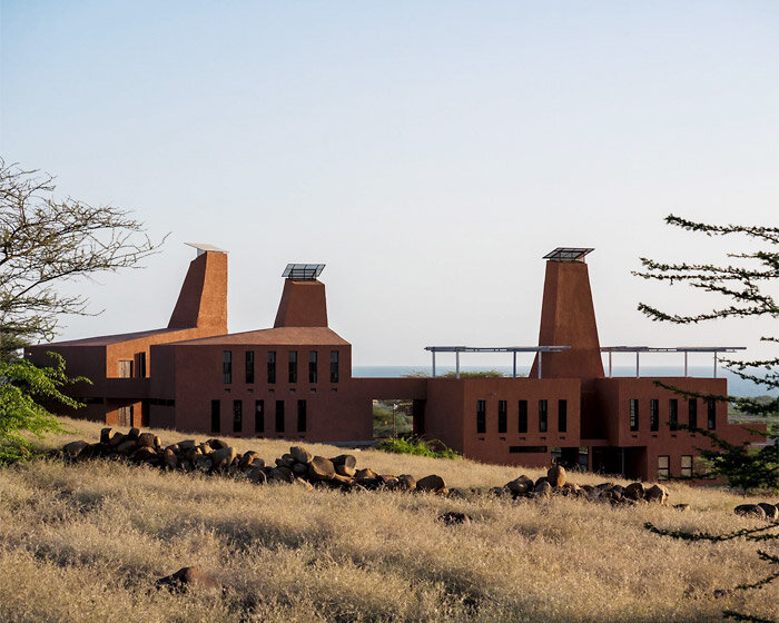 tall ventilation towers in kéré architecture's kenyan education campus mimic termite mounds