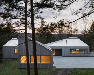 naturehumaine tops lake house in canada with sculptural slanted roofs + polygonal skylights