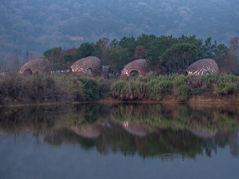 ZJJZ clads ellipsoidal guest houses in mirrored aluminum + pine shingles in rural china