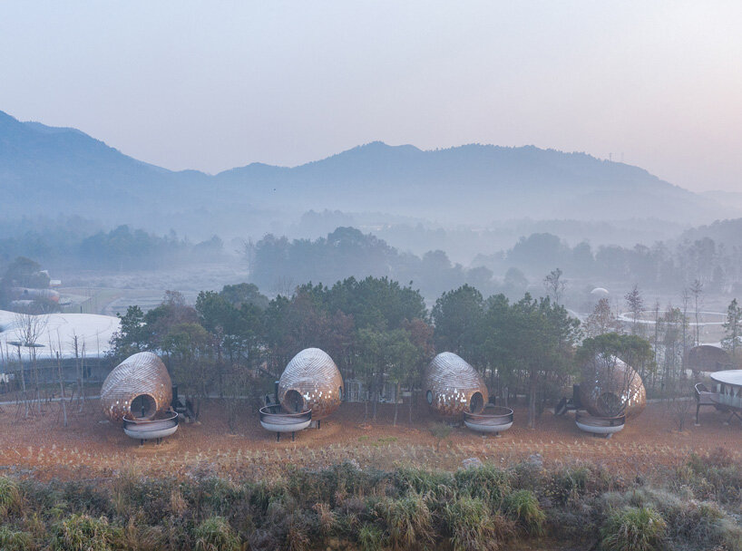 ZJJZ clads ellipsoidal guest houses in mirrored aluminum + pine shingles in rural china