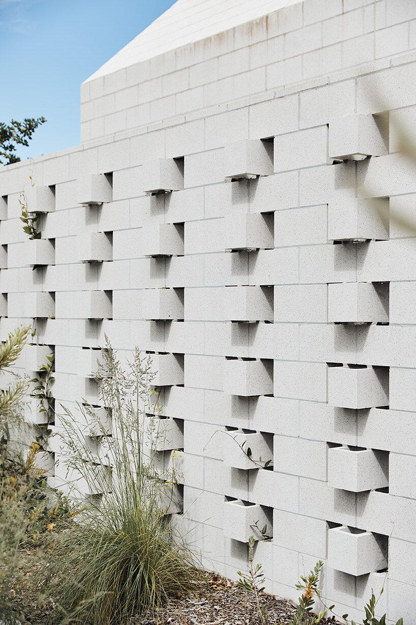 concrete masonry blocks + frustum roofs animate the façade of this beach house by architects EAT