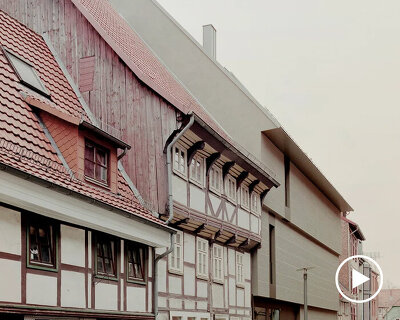 stacked paper and historical buildings inform the design of an art gallery in göttingen, germany